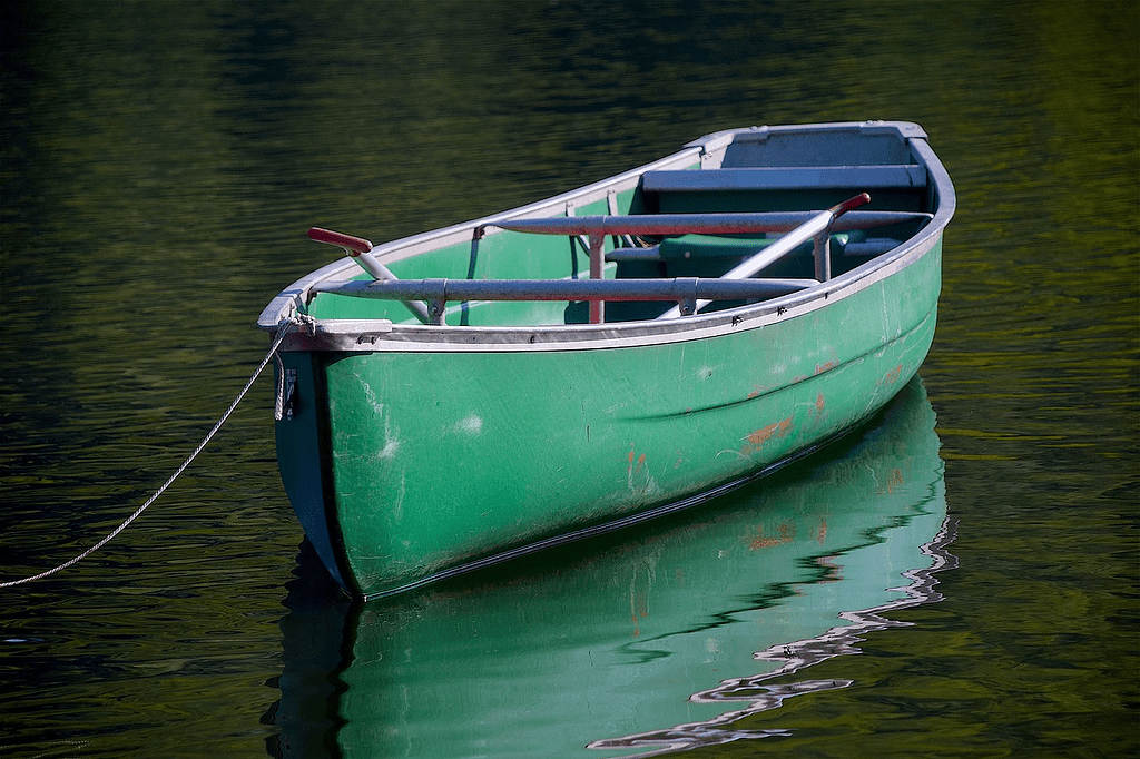 Green canoe in still water